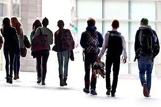 group_of_students_walking_into_universit_450